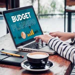 Woman sitting at computer, planning her budget