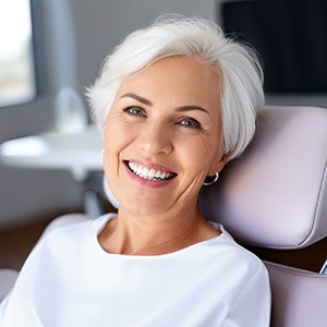 Smiling older woman in dental treatment chair