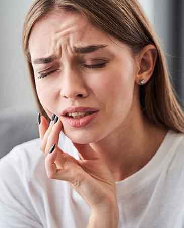 Woman with tooth pain needing emergency dentist in Colorado Springs