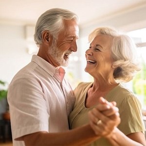 Older couple dancing in their living room